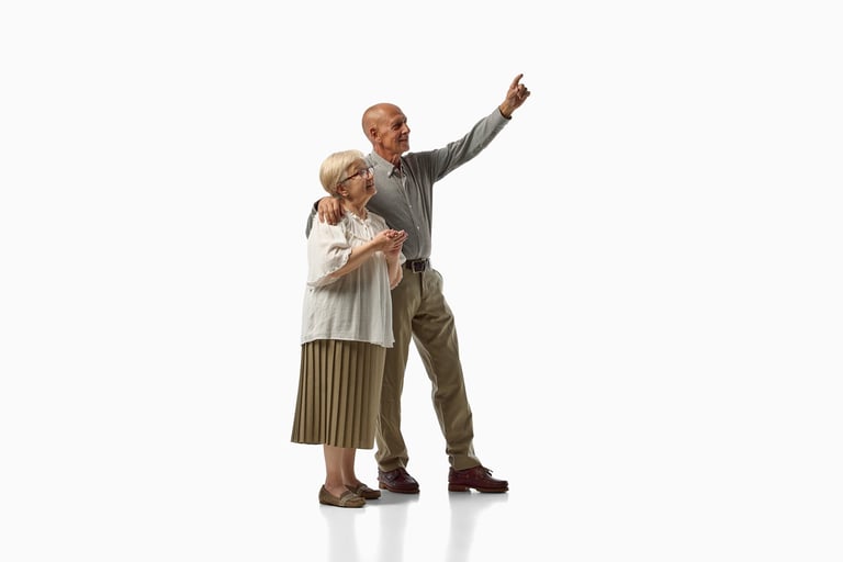 Senior couple pointing upward and looking ahead isolated on white background. Concept of image for AI learning, future planning, retirement goals, travel inspiration.